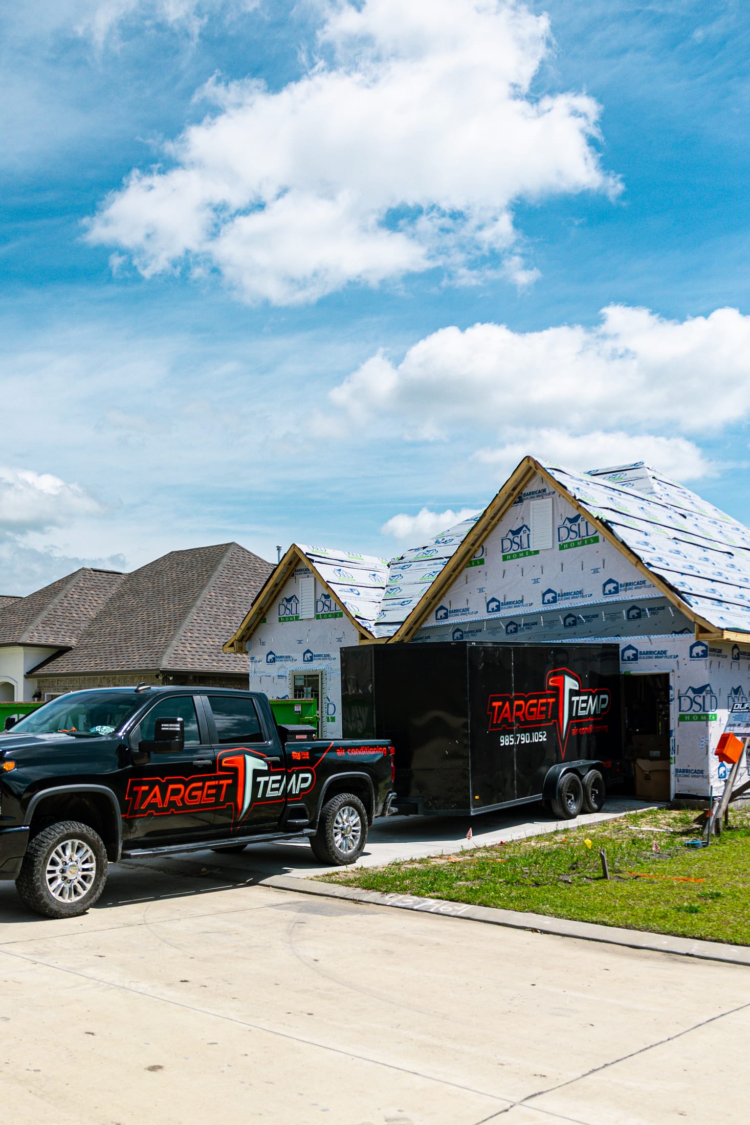 A branded client truck at a new build, shot on a content day